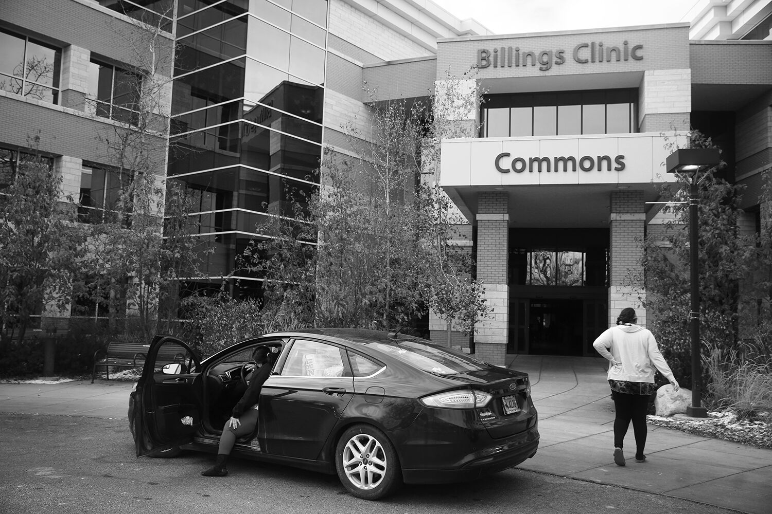 Jalissa rubs her back and walks toward the clinic